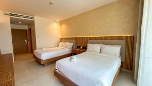 Ένα ή περισσότερα κρεβάτια σε δωμάτιο στο MantaHost Hotel