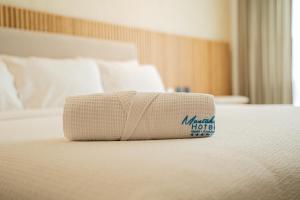 Ένα ή περισσότερα κρεβάτια σε δωμάτιο στο MantaHost Hotel