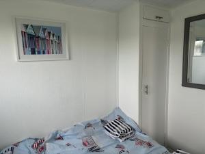 a bed in a room with a picture on the wall at Chalet 75 in Mundesley