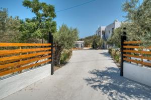 a gate to a road with trees and a building at Poetree Echo by Green Poetree Houses in Galatas