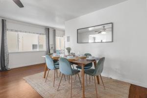 a dining room with a table and blue chairs at Coastal Hideaway in San Diego