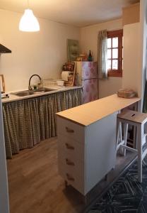 a kitchen with a counter and a sink and a refrigerator at Casa Maibeca in Bolbaite +15 photos
