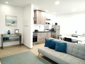 a living room with a couch and a kitchen at Casas de Campo - Real Mar in Ericeira