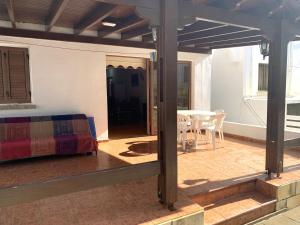 a room with a bed and a table on a patio at Sandy Beach Villas Sea View Apartment Pyla in Larnaka