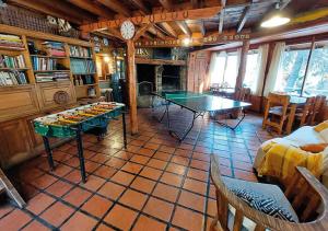 a living room with a ping pong table in it at Ruma Andina by DOT Cabana in Villa La Angostura