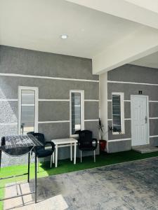 a living room with two chairs and a table at AMERICANA LUXURY APARTMENT in Lekki