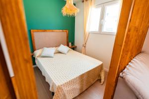 a small bedroom with a bed and a window at B - Studio Vista al Sol in Jávea +13 photos