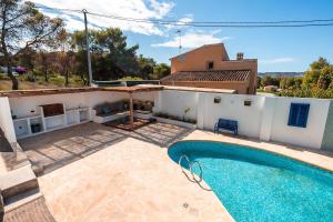 a villa with a swimming pool in front of a house at B - Studio Vista al Sol in Jávea