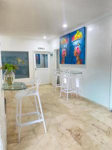 a room with chairs and a table and a painting at Hotel Cartagena Premium in Cartagena de Indias