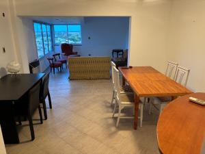 a living room with a dining room table and chairs at Departamento en Gualeguay in Gualeguay