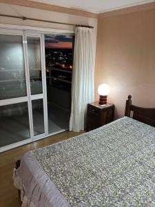 a bedroom with a bed and a large window at Departamento en Gualeguay in Gualeguay