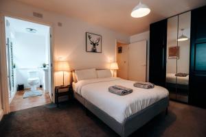 a bedroom with a bed with two towels on it at Prosper House Apartment 3 in Norwich +4 photos