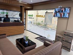 a living room with a couch and a tv at IVY Lemon Green in Bangalore