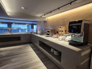 a kitchen with a counter with a coffee machine on it at Alassia Hotel in Athens