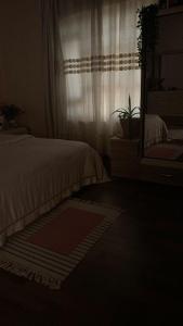 a bedroom with a bed and a mirror and a window at aLO MARRAKECH in Kasba Aït Youdi