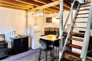 a kitchen with a table and a staircase in a room at Lodge des Cordeliers in Villard-Saint-Christophe
