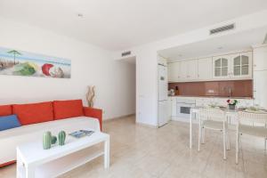a living room with a couch and a table at Nova Apartment by Hello Homes Sitges in Sitges +11 photos