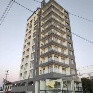 a tall apartment building with a lot of windows at Fenix 4 Alquiler Temporario in Formosa