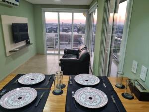 a living room with a table with plates on it at Fenix 4 Alquiler Temporario in Formosa