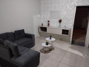 a living room with a couch and a table at Casa temporada em Caldas do Jorro in Tucano