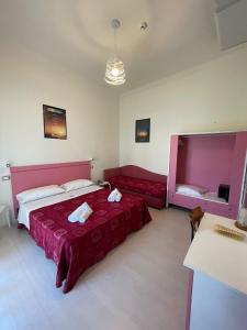 Postel nebo postele na pokoji v ubytování Hotel Dei Platani