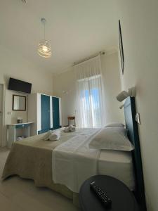 Postel nebo postele na pokoji v ubytování Hotel Dei Platani
