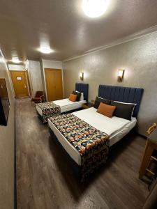 une chambre d'hôtel avec deux lits dans une chambre dans l'établissement Gimat Otel, à Yenimahalle 20 autres photos