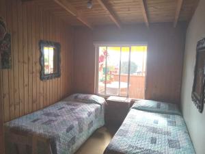 Postel nebo postele na pokoji v ubytování Cabañas Mirador de Soledad