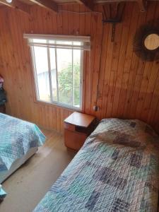 Postel nebo postele na pokoji v ubytování Cabañas Mirador de Soledad