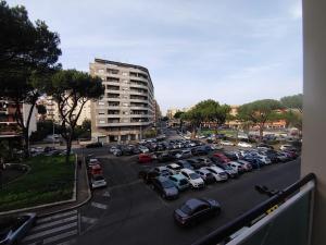 a parking lot with a lot of cars parked at "A casa dei Nonni" House near the metro C in Rome