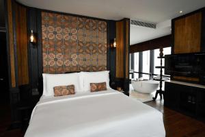 Voodi või voodid majutusasutuse The Orient Jakarta, a Royal Hideaway Hotel toas