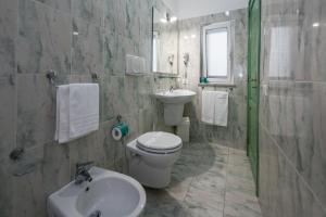 a bathroom with a toilet and a sink and a mirror at Ischia Dream Sunset in Ischia