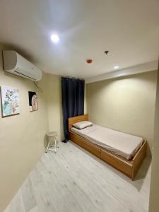 a small bedroom with a bed and a air conditioner at Cityscape Grand Tower Cebu - 2 Bedrooms with Balcony Close to Ayala Mall - New Condo in Cebu City