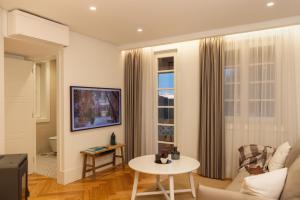 a living room with a couch and a table at Carvoeiro Boutique Apartments in Amarante
