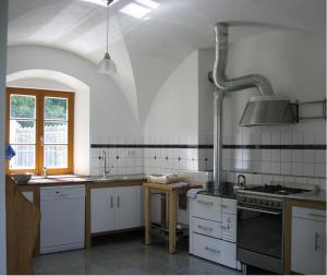 a kitchen with a sink and a stove at Helles Landhaus auf Waldlichtung in Dießen am Ammersee +20 photos
