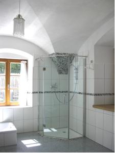 a glass shower in a bathroom with a window at Helles Landhaus auf Waldlichtung in Dießen am Ammersee +20 photos
