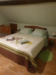a bedroom with a large bed with medicines on it at Gîte des Hirondelles in Issenheim