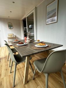 a table with chairs and plates of food on it at Buurman aan zee in Julianadorp +45 photos