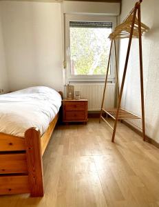 a bedroom with a swing bed and a window at Buurman aan zee in Julianadorp