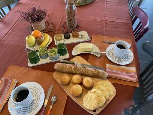 a table with a tray of food and cups of coffee at La Béraine in Saint-Bérain +9 photos