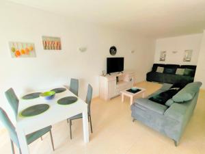 a living room with a table and a couch at DUNAS DO ALVOR by LTS Holidays - #127 in Alvor