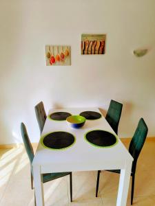a white table with chairs and a bowl on it at DUNAS DO ALVOR by LTS Holidays - #127 in Alvor
