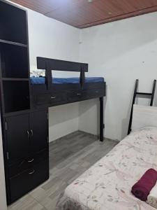 a bedroom with a bunk bed and a black dresser at Apartamento en La Colina in Macanal