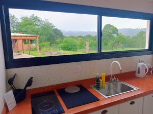 a kitchen counter with a sink and a window at Los 4 Vientos, Casa del Valle in San Javier
