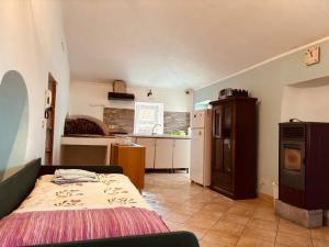 a bedroom with a bed and a kitchen at Al Castello in Valeriano Lunense
