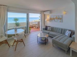 a living room with a couch and a table at Bliss Luz Horizon - Panoramic Sea View - 50m to Beach - Central Praia da Luz - Walk distance to Everywhere in Luz