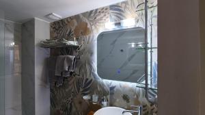 a bathroom with a shower and a sink and a mirror at Nero Apartment in Agrinion +13 photos