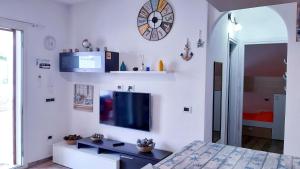 a living room with a flat screen tv on a wall at P I -G Ó 's HOUSE in Budoni