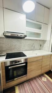a kitchen with a stove and a sink at Modern apartment in the heart of Tirana in Tirana