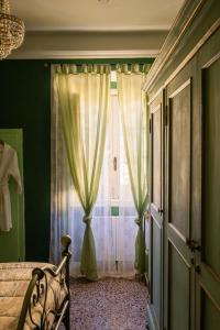 A bed or beds in a room at La Foresteria di Palazzo Picedi Benettini